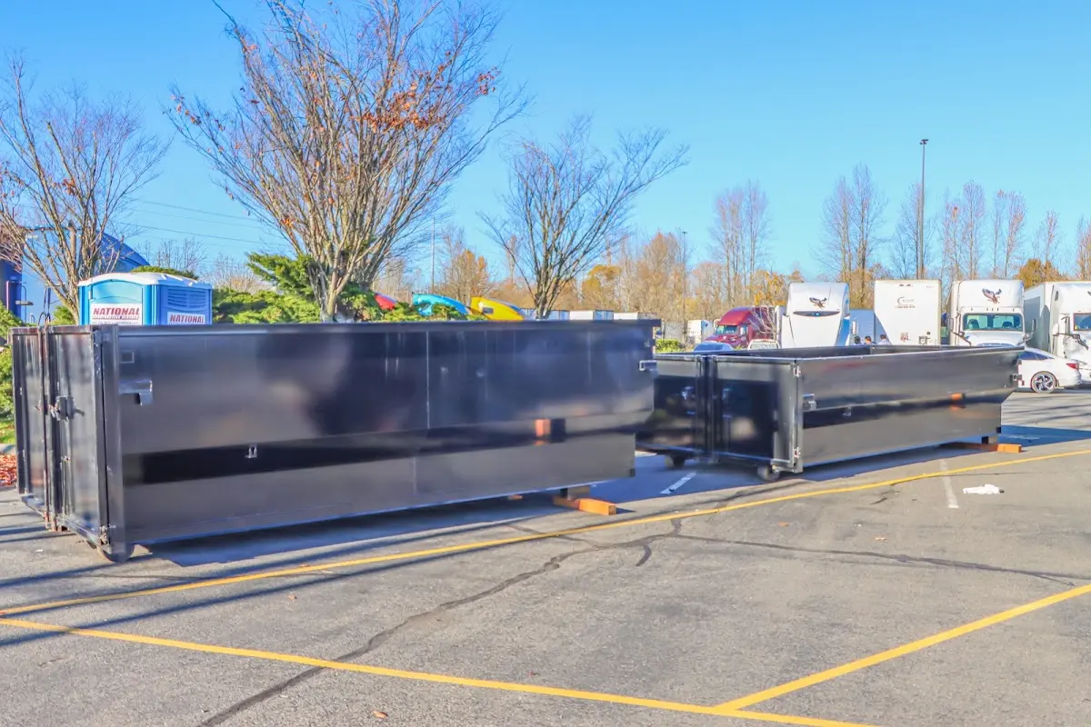 Professional dumpster rental service with roll-off container on residential driveway in Ankeny